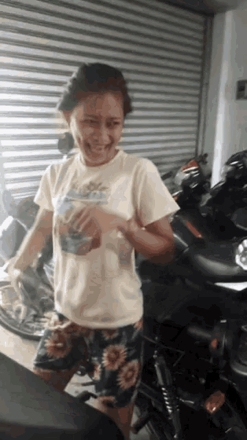 a woman wearing a shirt that says ' hawaii ' on it is smiling