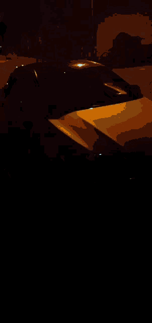 a close up of a car 's headlight with a yellow glow