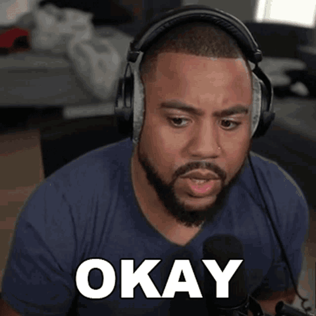 a man wearing headphones has the word okay written on his face