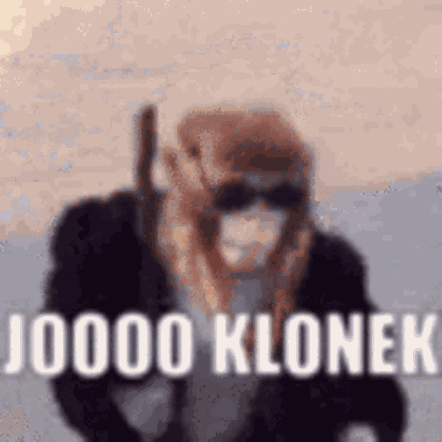 a monkey wearing sunglasses and a mask is holding a gun and says `` 00000 klonek '' .