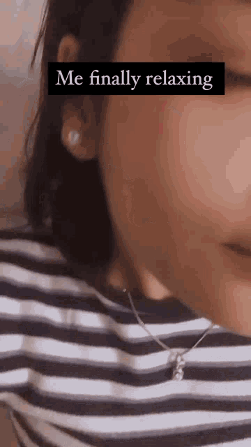 a close up of a woman 's face with the words `` me finally relaxing '' written on it .