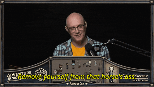 a man in a plaid shirt stands in front of a microphone with the words adventure is nice remove yourself from that horse 's ass