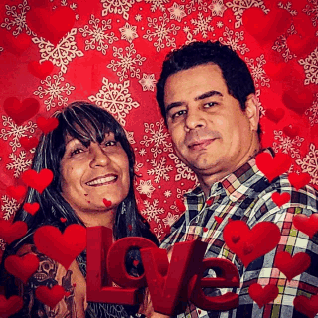 a man and a woman are posing for a picture with the word love in the foreground