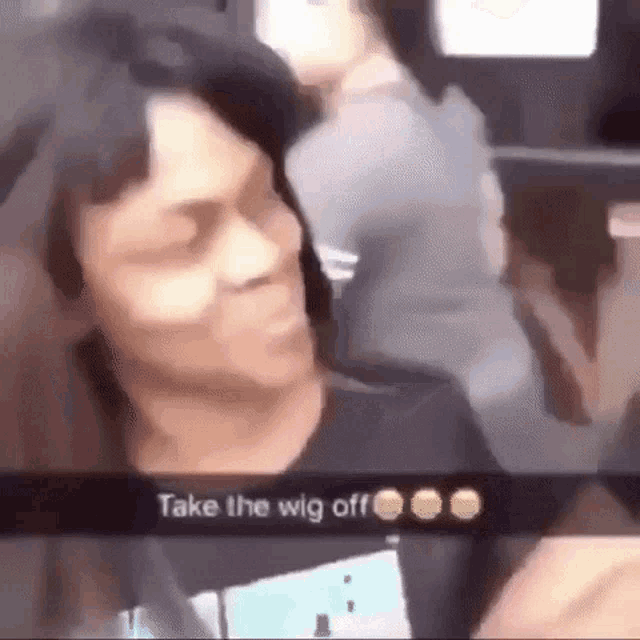 a man with a wig on his head is taking a selfie with a woman .