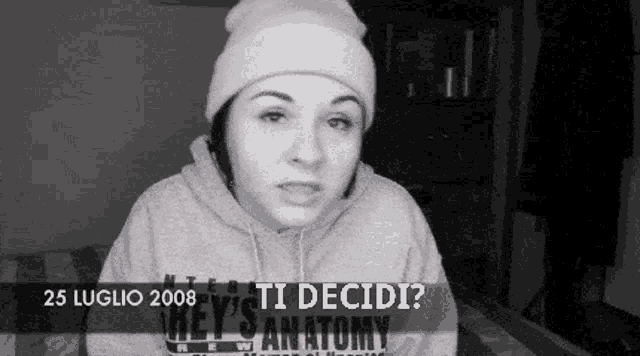 a black and white photo of a woman wearing a grey 's anatomy hoodie