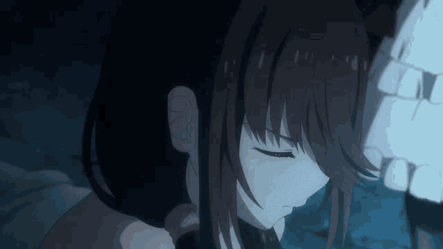 a close up of a girl with her eyes closed in a dark room