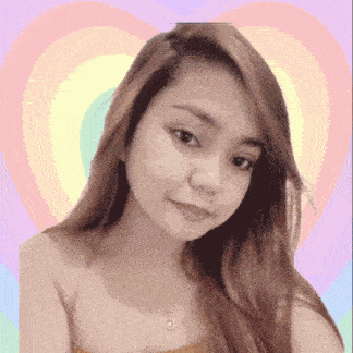 a woman with long hair is standing in front of a colorful heart