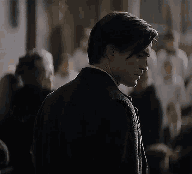 a man in a suit and tie is looking down