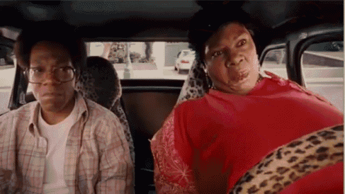 a man and a woman are sitting in a car