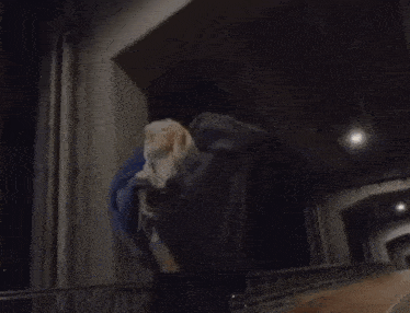 a person is walking down a street at night