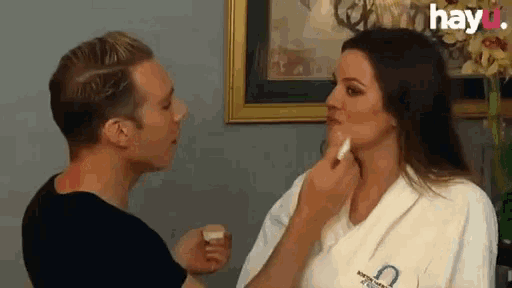 a man is applying makeup to a woman 's face with hayu written on the bottom of the image