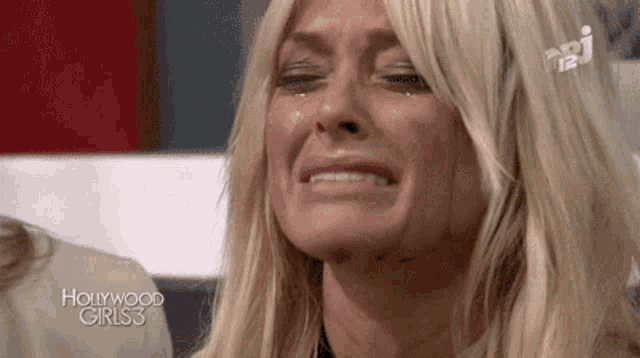 a woman is crying while watching hollywood girls3