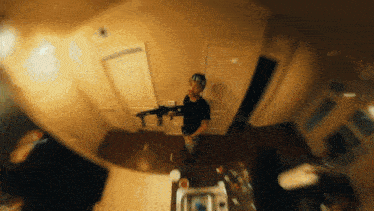 a blurry picture of a man holding a rifle