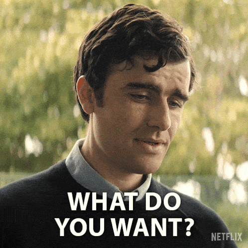 a man is asking what do you want with a netflix logo behind him