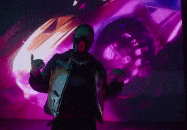 a man wearing a mask and a jacket with a skull on it is standing in front of a purple background .