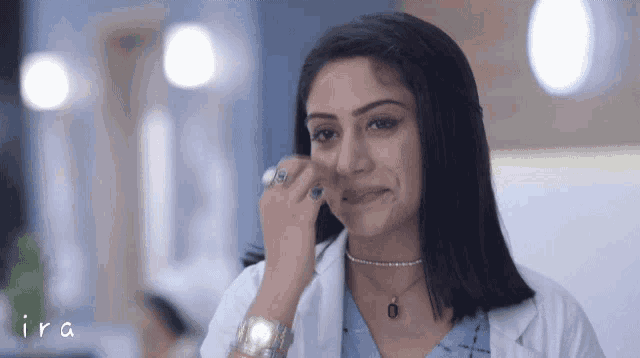 a woman in a lab coat is crying and the word ira is visible in the corner
