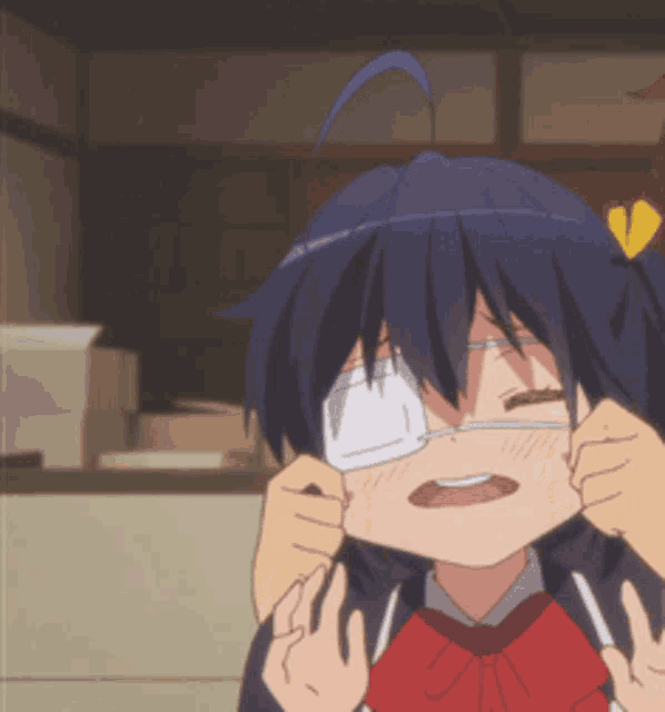 a girl with glasses and a red bow tie has her eyes closed