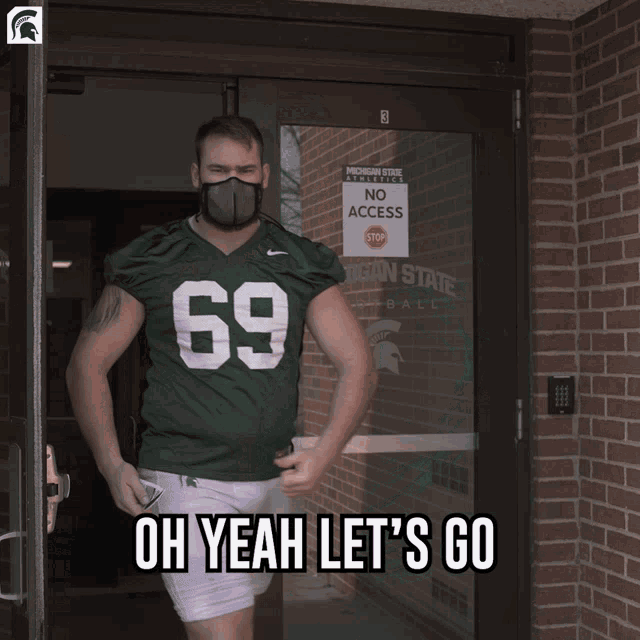 a man wearing a green jersey with the number 69