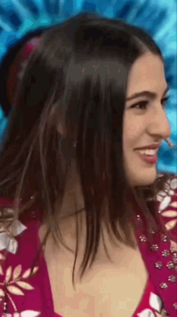 a close up of a woman 's face with a pink shirt on
