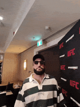 a man standing in front of a ufc banner