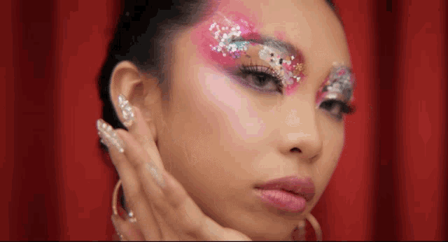 a close up of a woman with makeup on her face