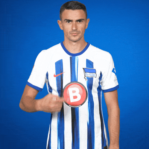 a man in a blue and white striped shirt with the letter b on the front
