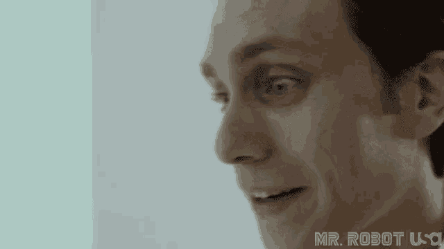 a close up of a man 's face with the words `` mr. robot '' on the bottom .
