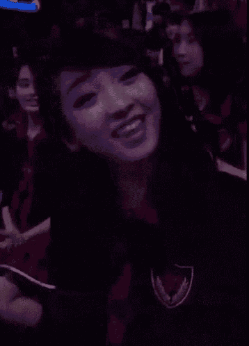 a woman with her hand on her chest is smiling
