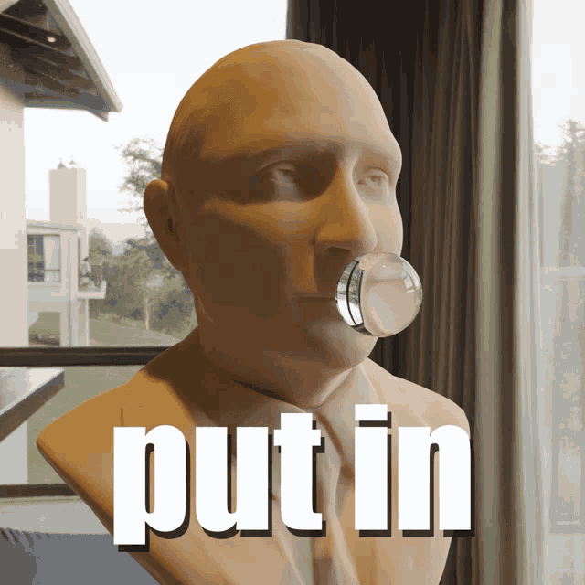 a statue of a man with a bubble in his mouth and the word put in behind him