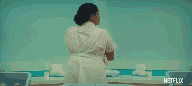 a nurse is holding a baby in her arms with a netflix logo in the corner