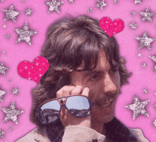 a man wearing sunglasses has a heart on his head