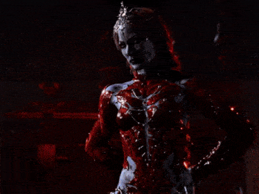 a man is being attacked by a red monster in a dark room