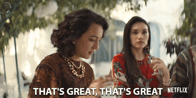 a woman says that 's great while sitting at a table