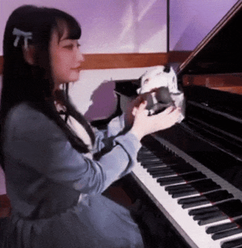 a girl is playing a piano with a purple background