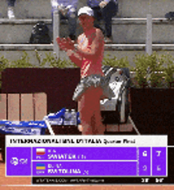 a tennis player is standing on a court with a purple sign that says ' international ' on it