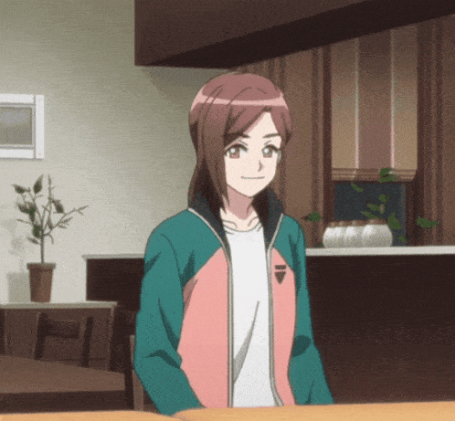 a girl in a pink and green jacket with the letter i on the front
