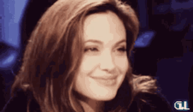 a close up of a woman 's face with the letter t on the bottom left