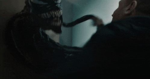 a man is being attacked by a monster with sharp teeth