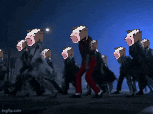 a group of people with cows on their heads are walking in the dark