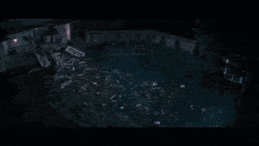 an aerial view of a destroyed house with a pool