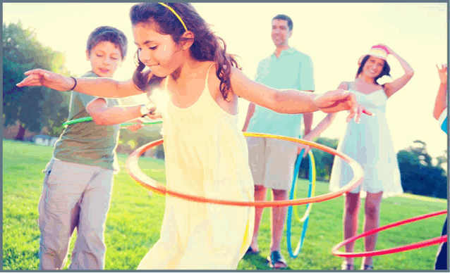 a group of children are playing with hula hoops