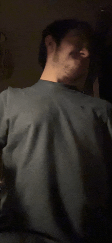 a man with a beard is wearing a gray shirt