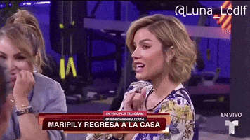 two women sitting in front of a sign that says " maripily regresa a la casa "