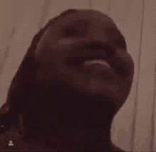 a close up of a man 's face with a beard looking up at the camera .