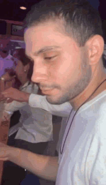 a man with a beard is sitting at a table
