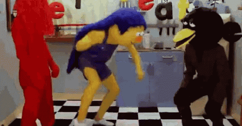 a group of stuffed animals are dancing on a checkered floor .