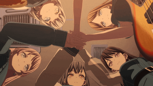 a group of anime girls are putting their hands together in a circle
