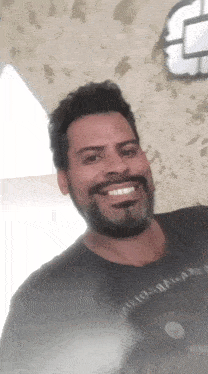 a man with a beard is wearing a black shirt that says apollo on it