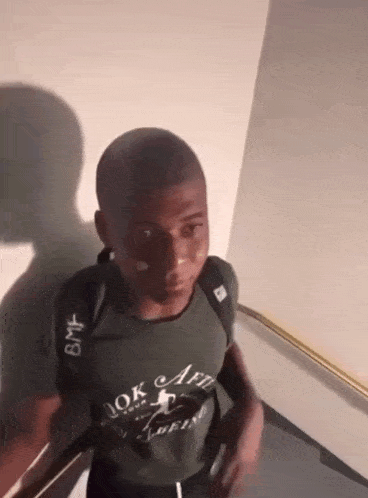 a man wearing a shirt that says " ok art " on it