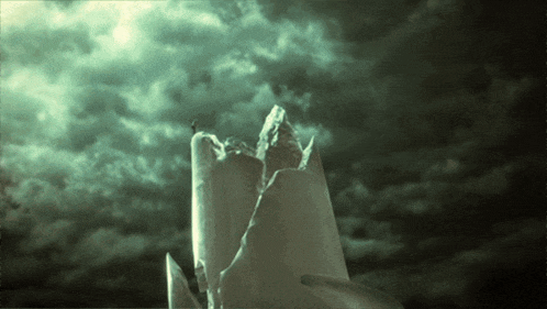 a broken candle against a cloudy sky